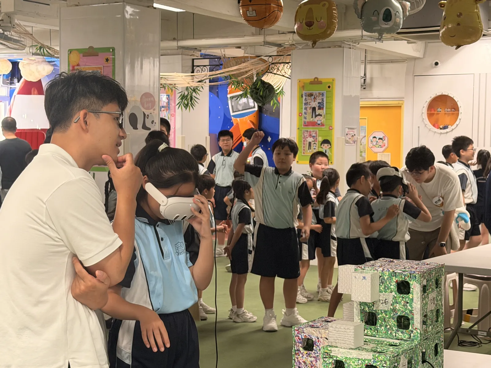 Students observing the recycling learning station